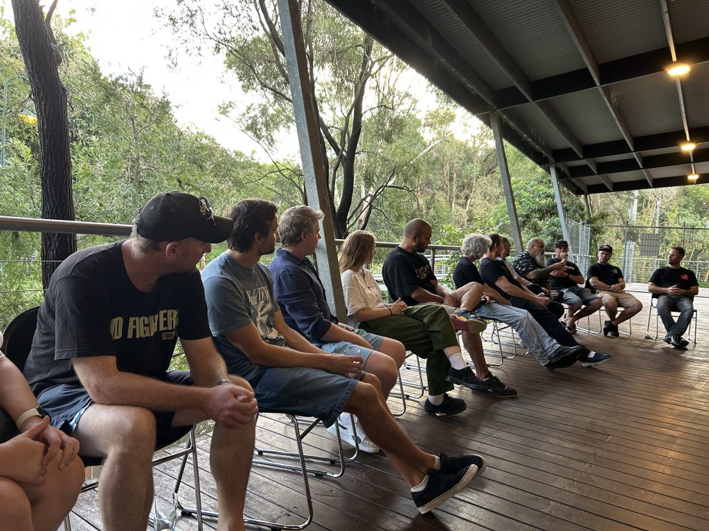 a group of people in a circle workshop at the next set