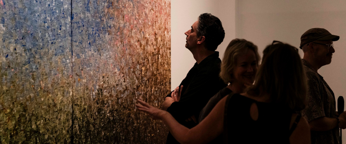Image of a man looking at artwork at the Noosa Regional Gallery in Tewantin on the Sunshine Coast.