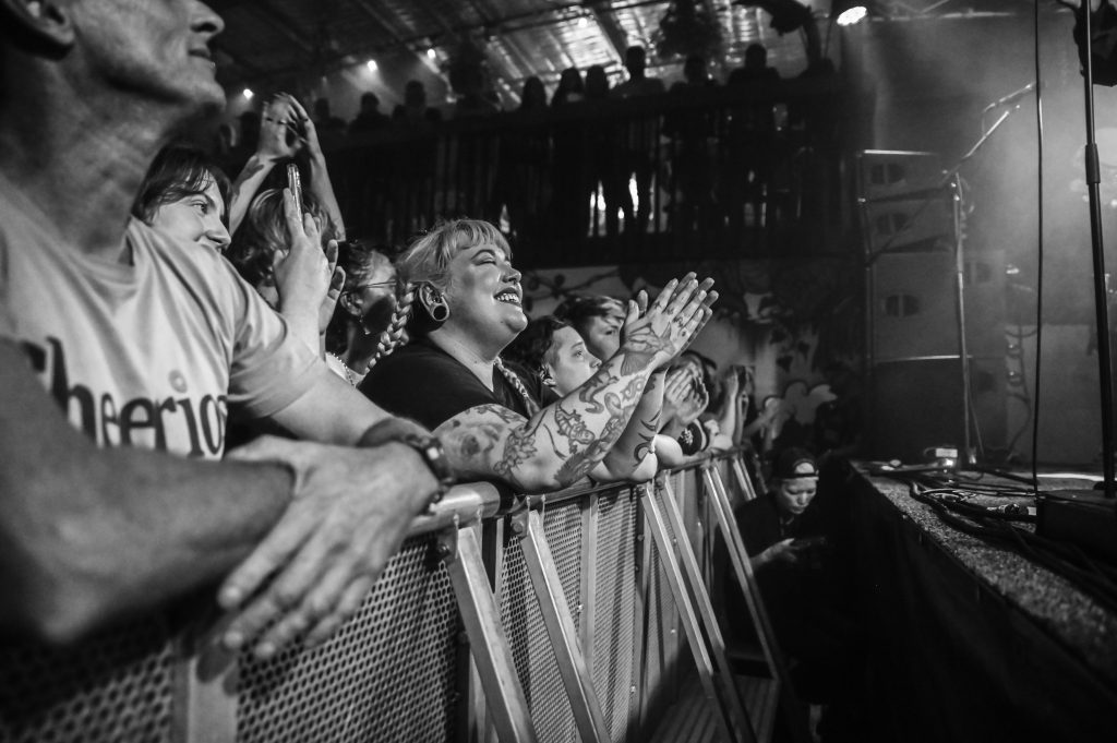 Black and white photo of a female in the front row enjoying Enter Shikari at Blackflag Brewing.
