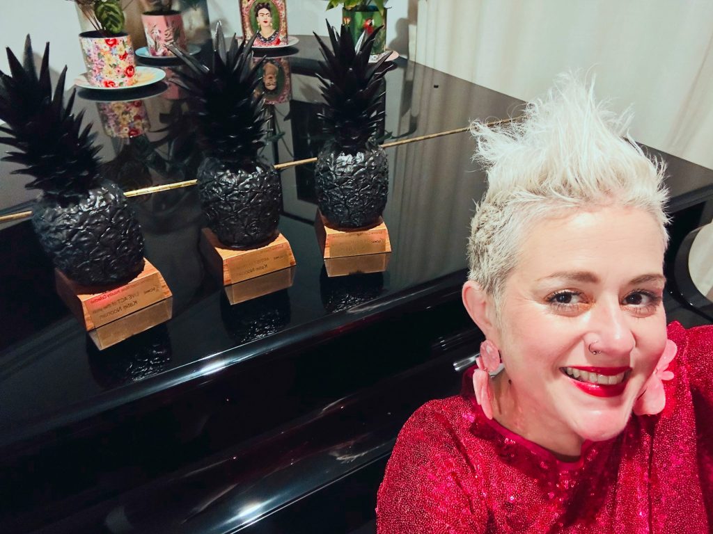 Katie Noonan with her three awards (wood carvings of pinapples).
