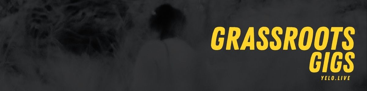 "Grassroots Gigs" banner: Black and white image of blurry grassy scenery with yellow text.