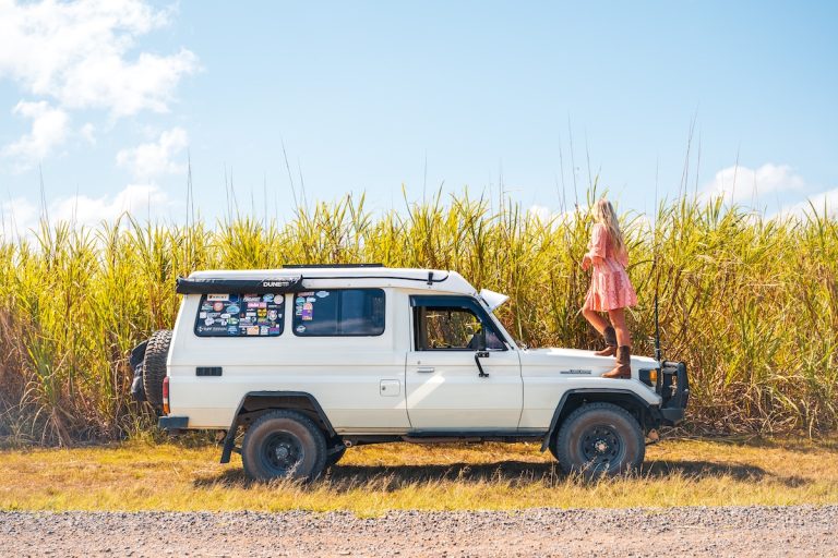 Sunshine Coast musician Sari Abbott sitting on a car during a promotional photoshoot.