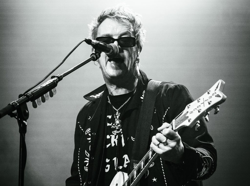 Chris Cheney on stage.