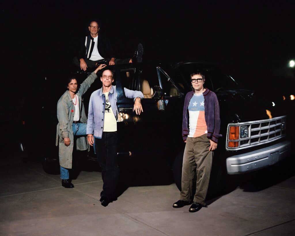 Weezer band members beside a van